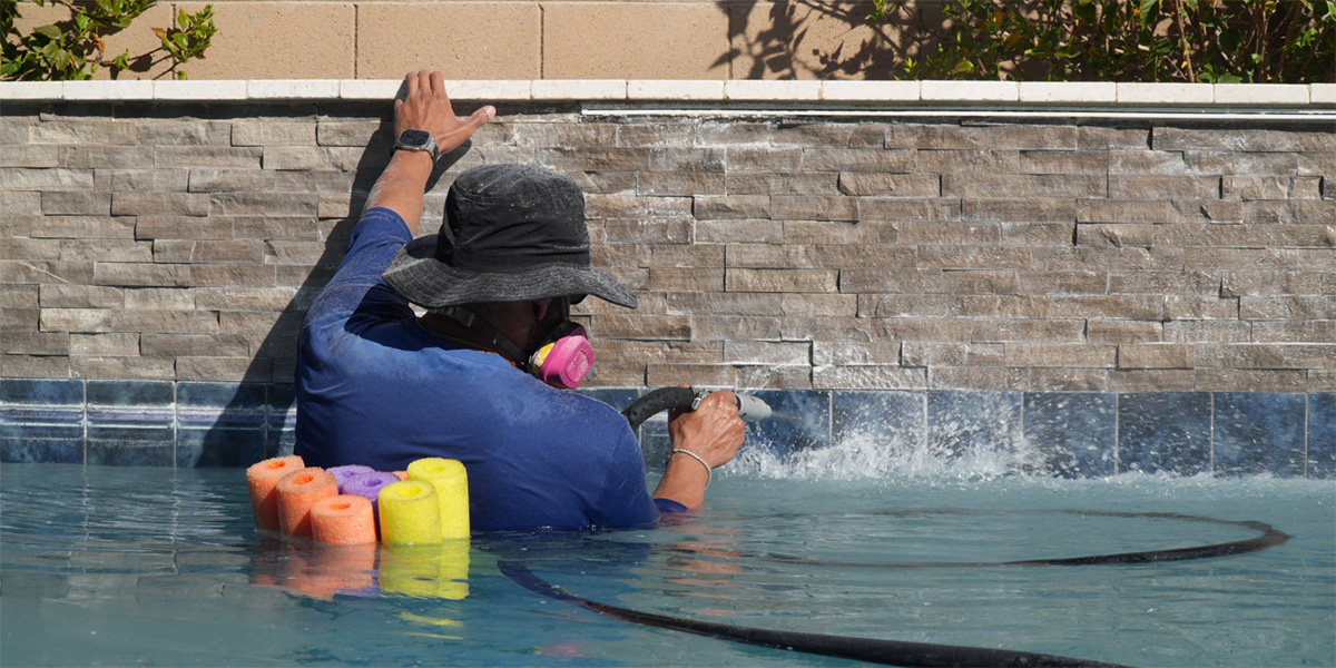 Pool cleaning company removing calcium stains from pool tiles